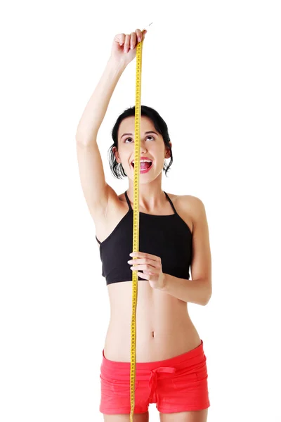Atractivo ajuste mujer delgada con cinta métrica . —  Fotos de Stock