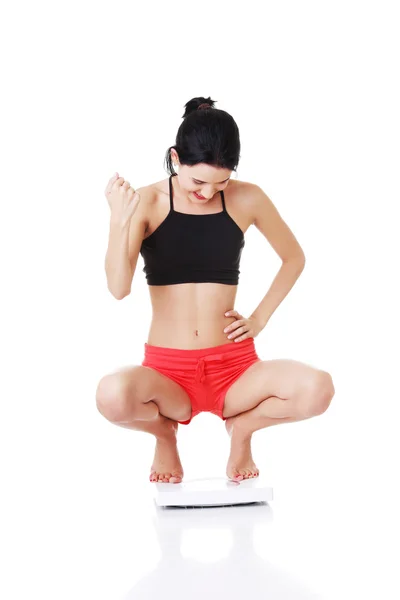 Mujer joven en agacharse en ropa deportiva . — Foto de Stock