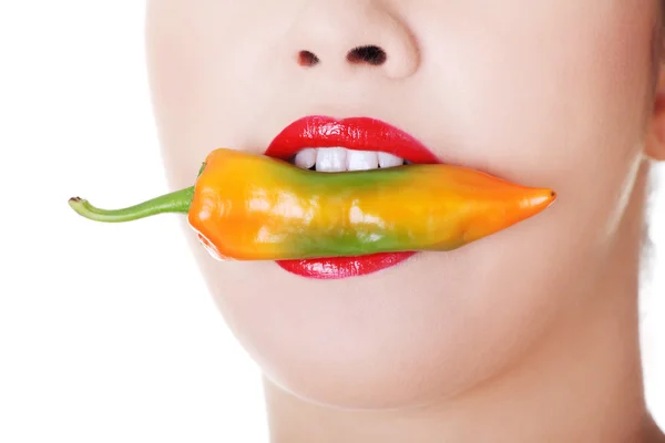 Female mouth with chilii pepper inside. Close up. — Stock Photo, Image