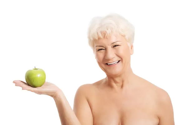 Naakt oude vrouw houden en apple. — Stockfoto