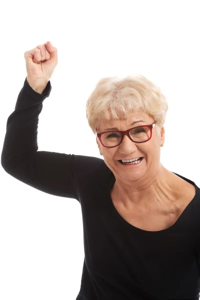 Happy old woman having closed fists. Stock Photo