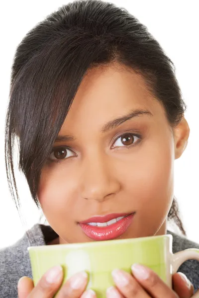 Young woman drinking something from big mug — Stock Photo, Image