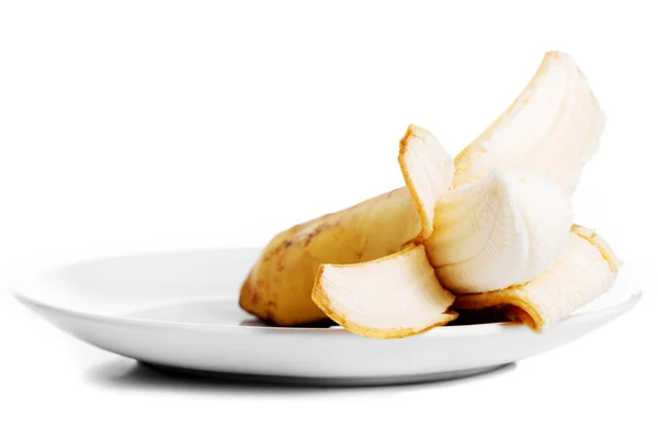 Pilled banana lying in a white bowl. — Stock Photo, Image