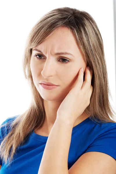 Portrait of young casual woman touching her face. — Stock Photo, Image