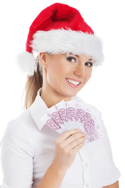 Młody biznes kobieta trzyma pieniądze w santa hat. — Zdjęcie stockowe
