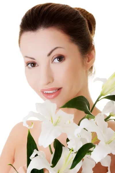 Portrait of beautiful adult woman with health skin and with lily — Stock Photo, Image