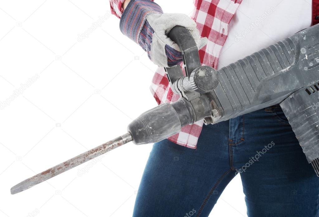 Casual woman holding jackhammer.
