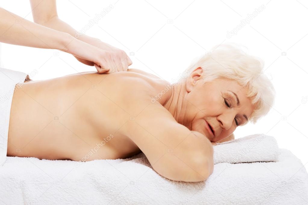 An old woman is having a massage. Spa concept.