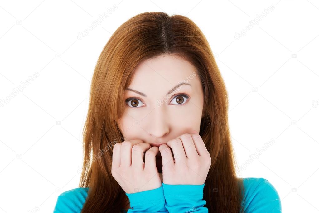 Attractive casual woman expressing fear, worries.