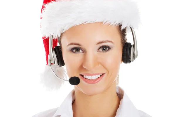 Joven mujer de negocios en sombrero de santa, micrófono y auriculares . —  Fotos de Stock