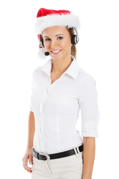Young business woman in santa hat, microphone and headphones. — Stock Photo, Image