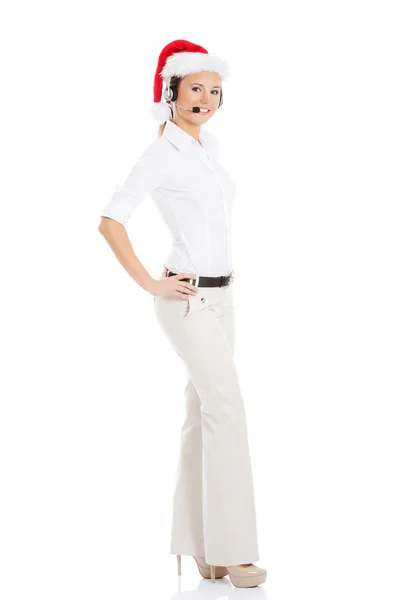 Young business woman in santa hat, microphone and headphones. — Stock Photo, Image