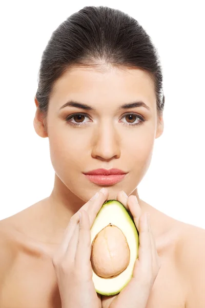 Beautiful woman's face with avocado. — Stock Photo, Image