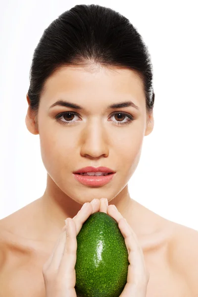 Beautiful woman's face with avocado. — Stock Photo, Image