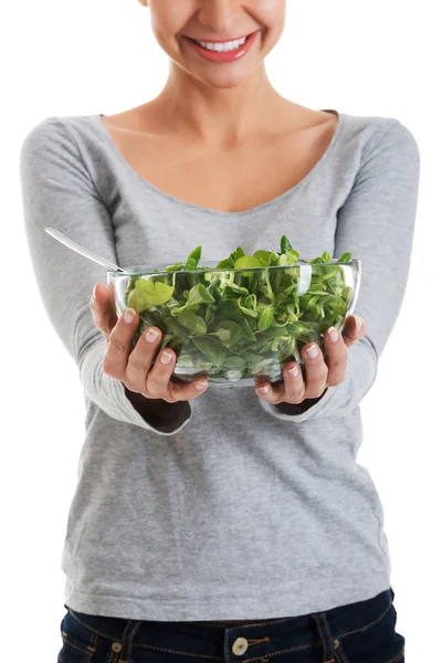 Young casual woman eating lamb's lettuce. — Stock Photo, Image