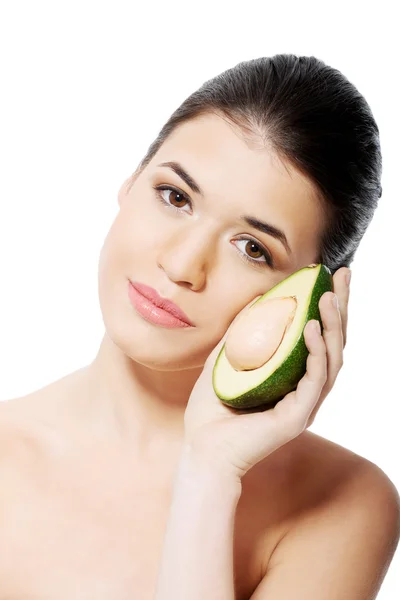 Beautiful woman holding avocado. — Stock Photo, Image