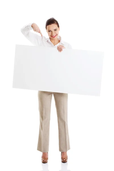 Beautiful business woman pointing on copy space. — Stock Photo, Image