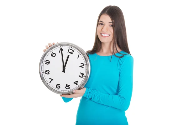 Young casual woman is holding a clock. Stock Image