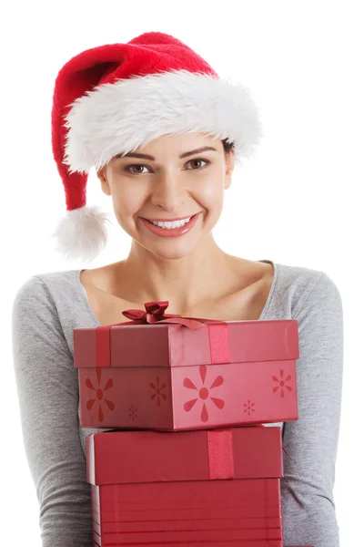 Beautifull woman in santa hat holding presents. Stock Photo