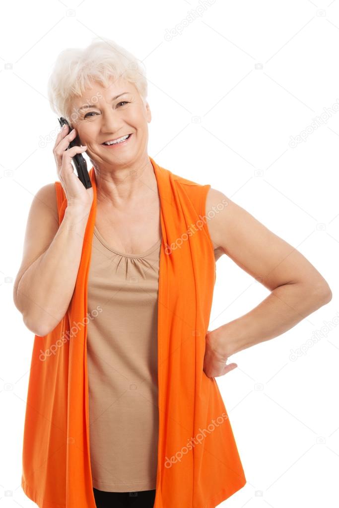 An old woman talking through phone.