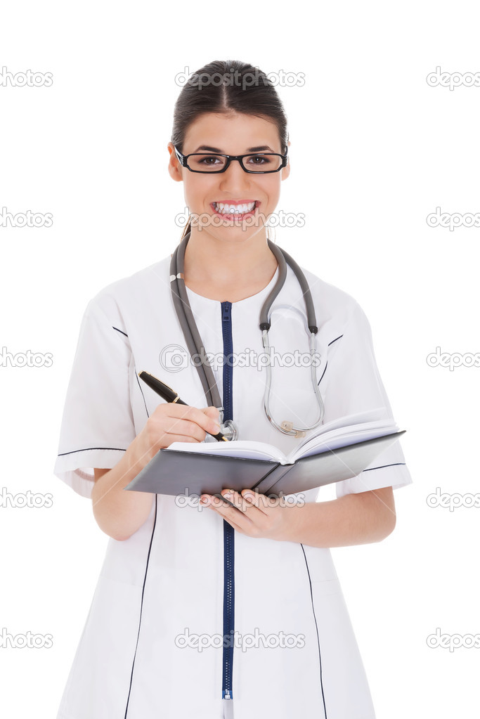 Young female doctor wirting in a book.