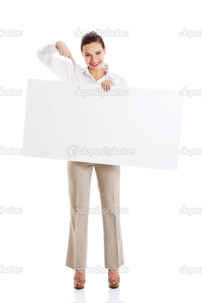 Beautiful business woman pointing on copy space.