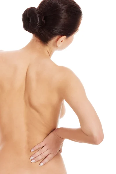 Bella donna nuda sta avendo mal di schiena . — Foto Stock