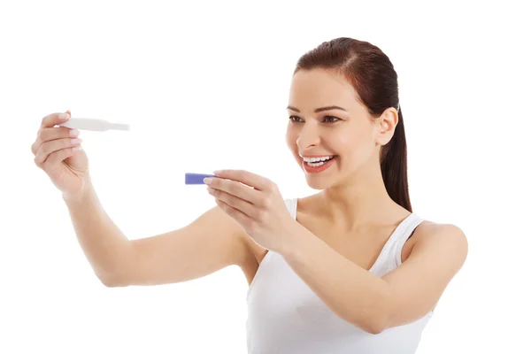 Happy beautiful young woman with pregnancy test. — Stock Photo, Image