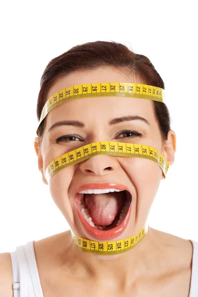 Krásná ženská tvář s měřicí páska. — Stock fotografie