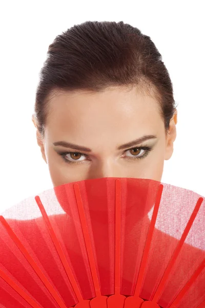 Beautifull woman in sexy red dress with fan. — Stock Photo, Image