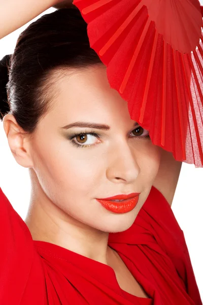 Schöne Frau in rotem sexy Kleid mit Fächer. — Stockfoto
