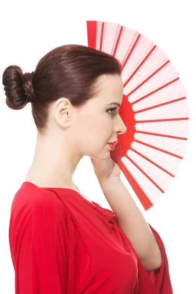 Beautiful woman in red sexy dress with fan. — Stock Photo, Image