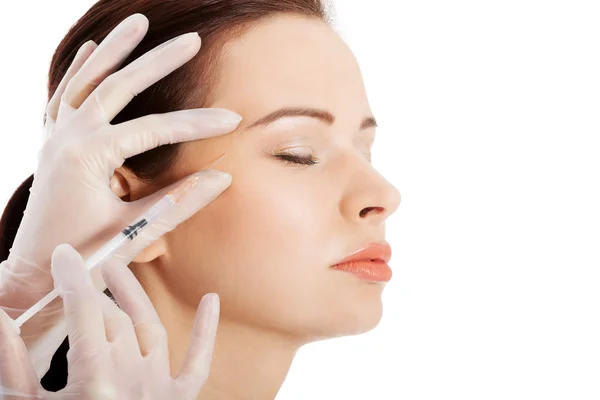 Beautiful woman's face is being prepareg to plastic surgery. Stock Photo