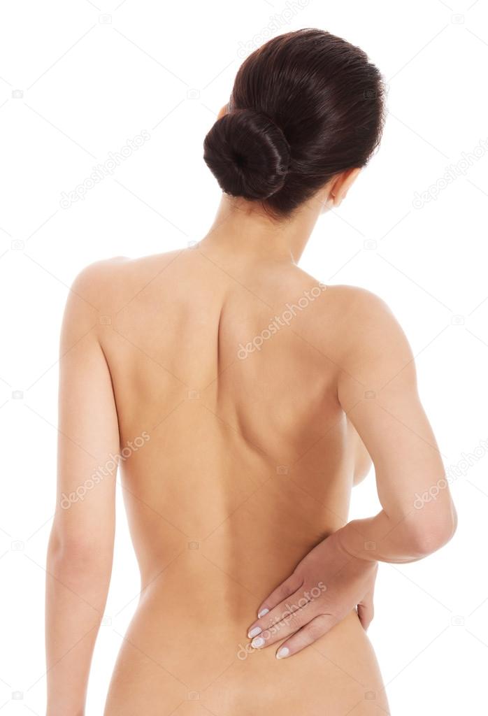 Beautiful naked woman is having backache.