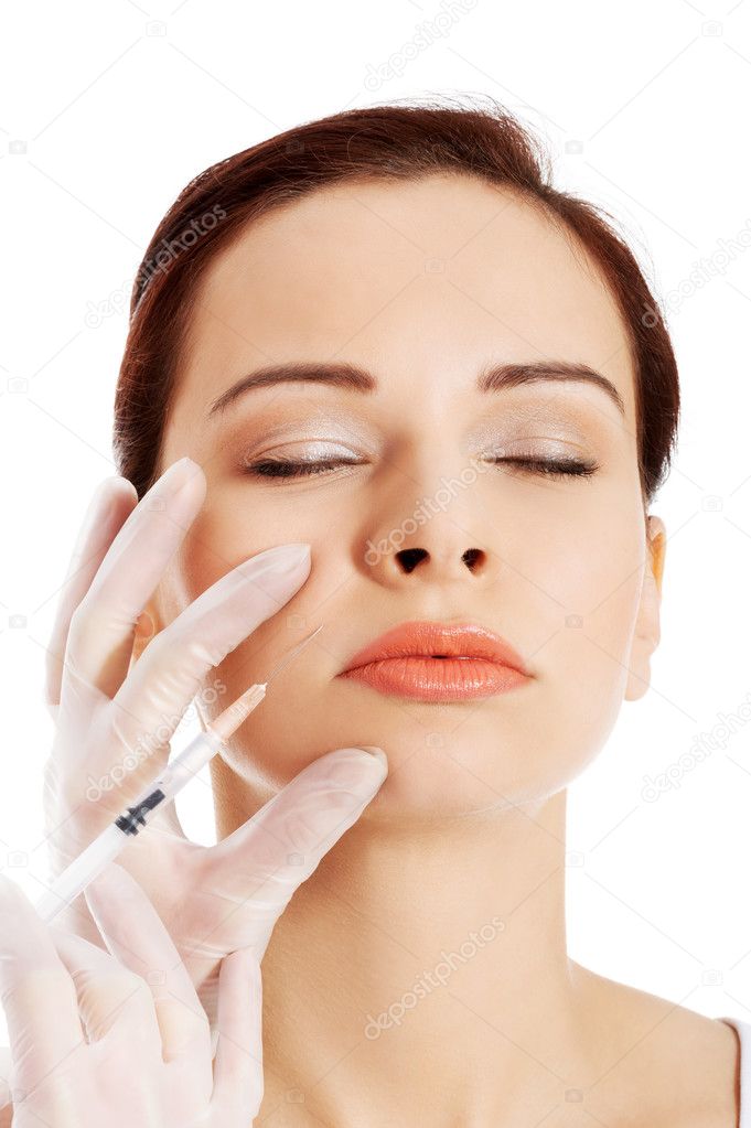 Beautiful woman's face is being prepareg to plastic surgery.