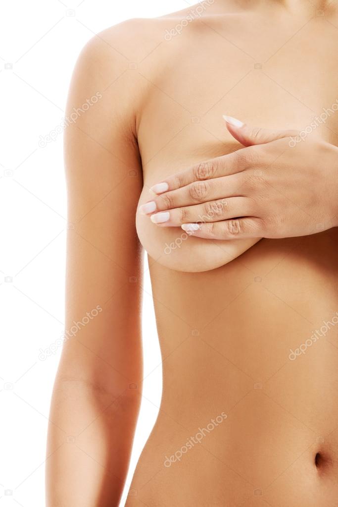 Naked beautiful woman holding her breast.