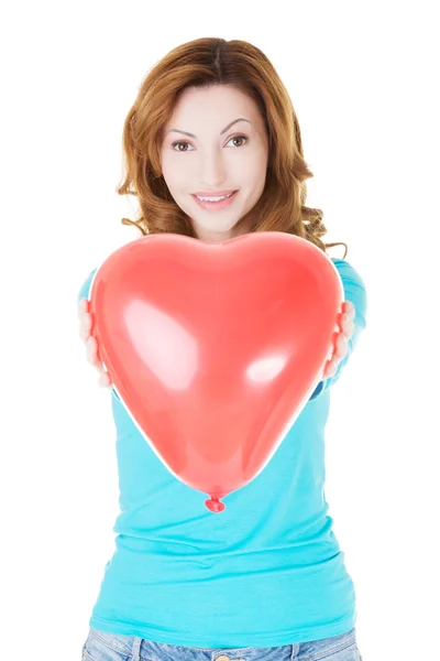 Attractive woman giving a baloon heart. — Stock Photo, Image