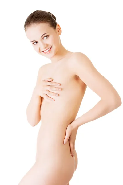 Attractive young naked woman holding her breasts. Back view. — Stock Photo, Image