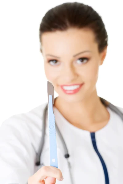Attractive young female doctor with scalpel. Stock Image