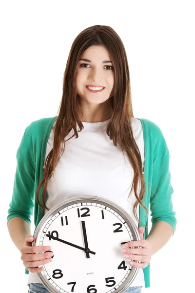 Young casual woman holding clock. Royalty Free Stock Photos