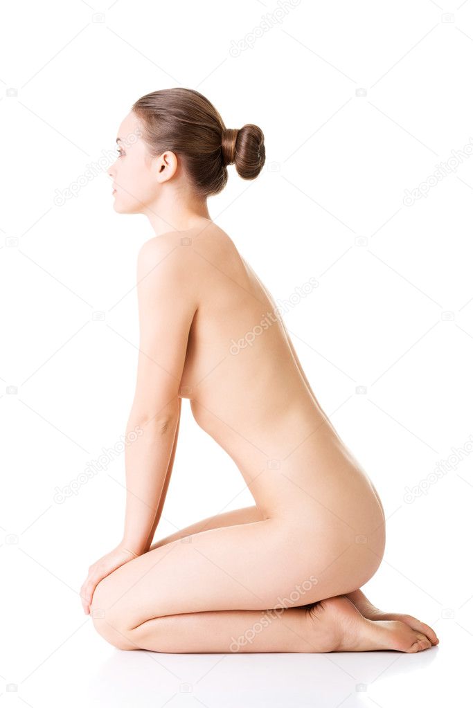 Attractive naked woman in a crouch.