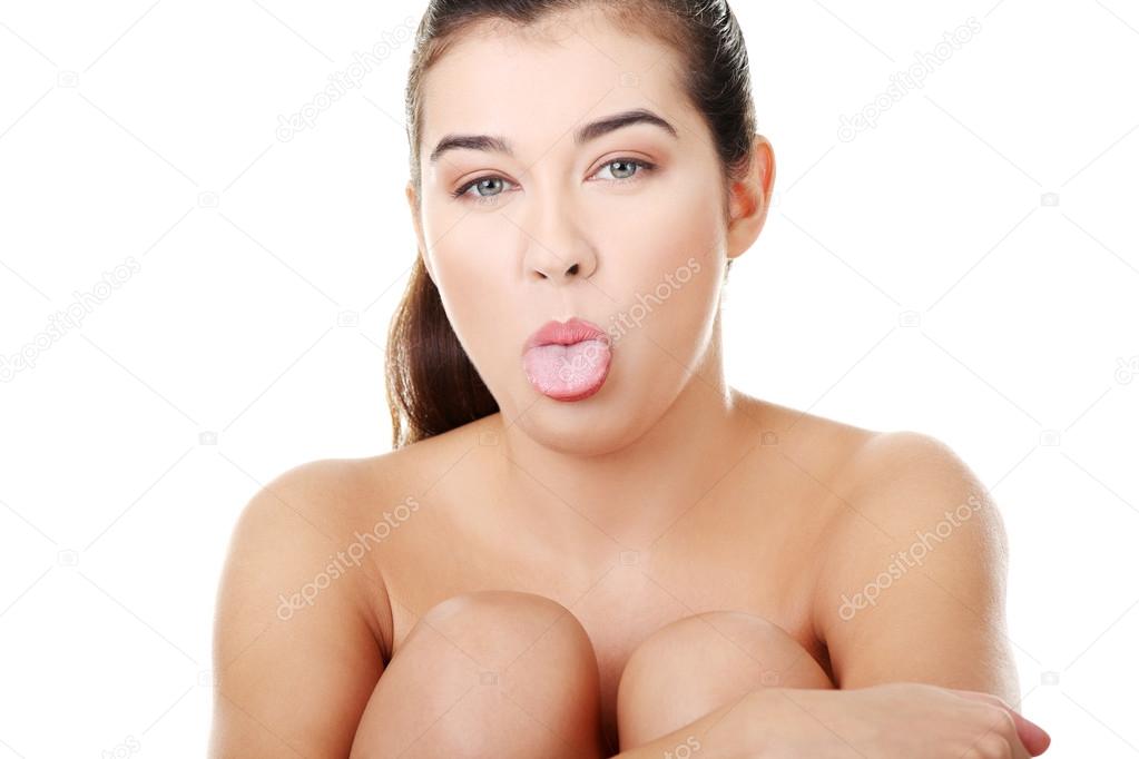 Beautiful naked woman with tongue outside the mouth.