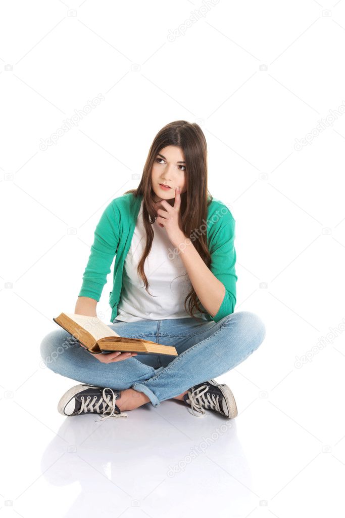 Young beautiful student sitting with book, reading, learning.