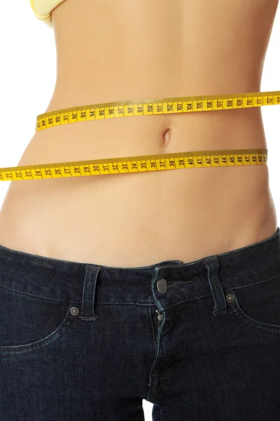 Slim woman's body with measuring tape. — Stock Photo, Image