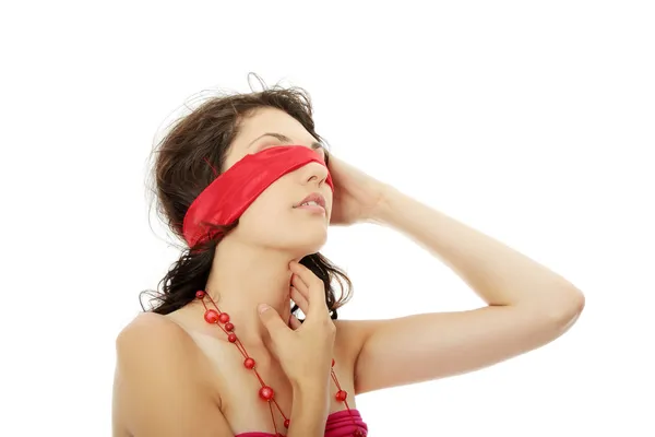 Young beautiful brunette with red eyeband and necklace. — Stock Photo, Image