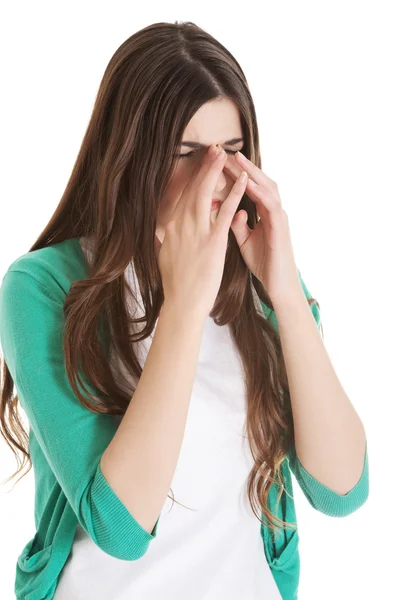 Young beautiful woman with sinus pressure, touching her nose. — Stock Photo, Image