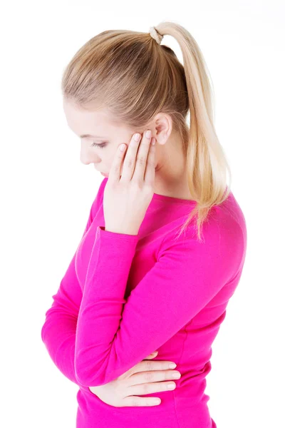 Beautiful casual woman is touching her temples. — Stock Photo, Image