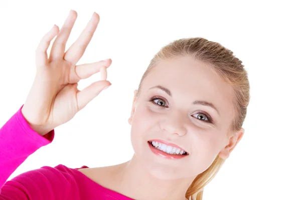 Young beautiful woman holding a pill. — Stock Photo, Image