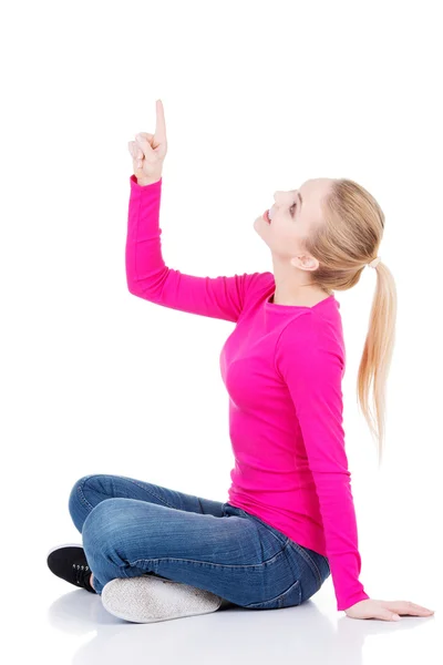 Young beautiful casual woman pointing up. — Stock Photo, Image