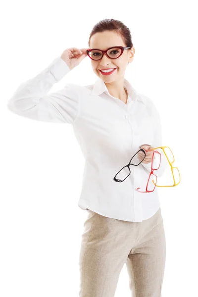 Beautiful woman in eyeglasses holding three different pair of ey — Stock Photo, Image